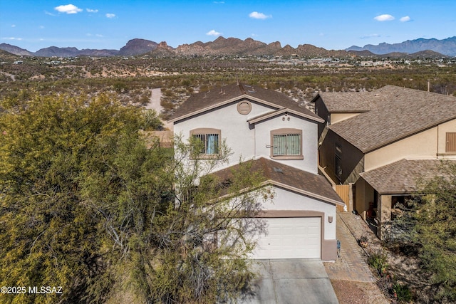 view of front of home featuring a garage and a mountain view