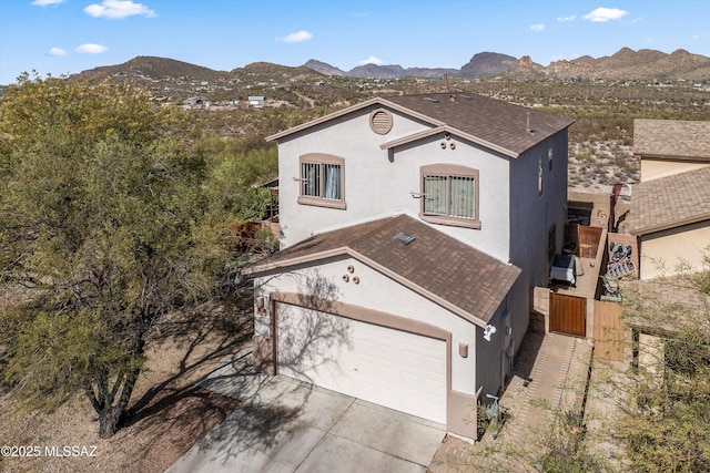 ranch-style house featuring a garage and a mountain view