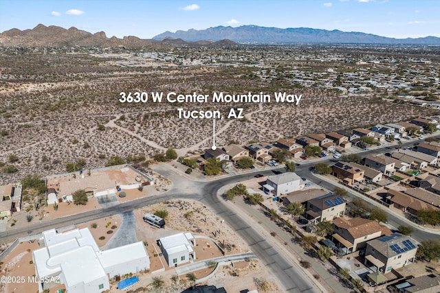 birds eye view of property with a mountain view