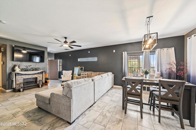 living room with a fireplace and ceiling fan