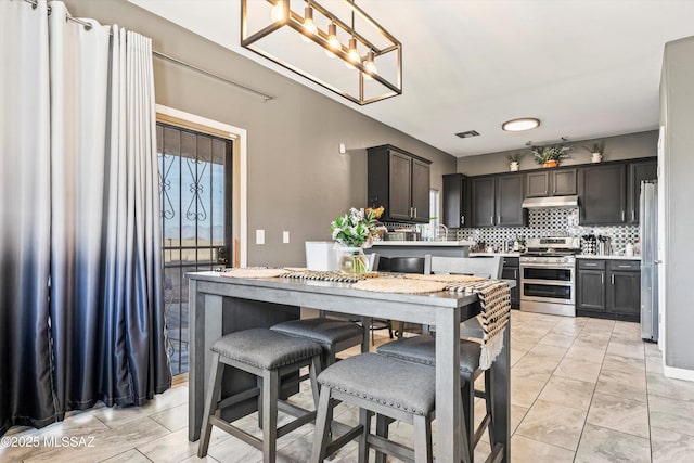 dining space featuring a notable chandelier