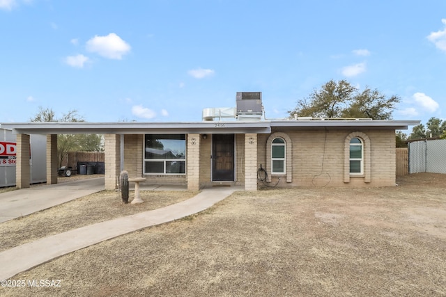 ranch-style home featuring cooling unit and a carport