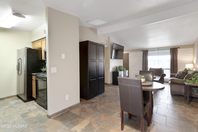 dining room featuring lofted ceiling with beams