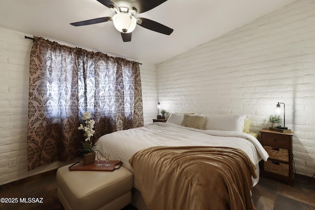 bedroom with vaulted ceiling, brick wall, and ceiling fan