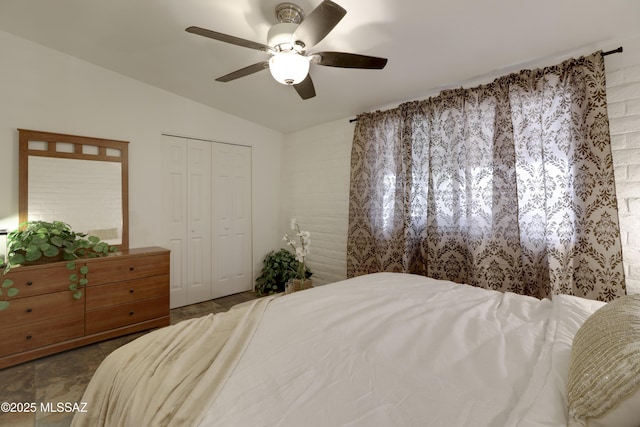 bedroom with vaulted ceiling, ceiling fan, and a closet