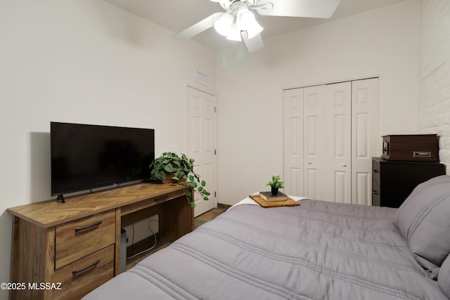 bedroom with ceiling fan and a closet