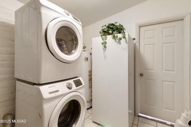 washroom with gas water heater, stacked washer and clothes dryer, and light tile patterned flooring