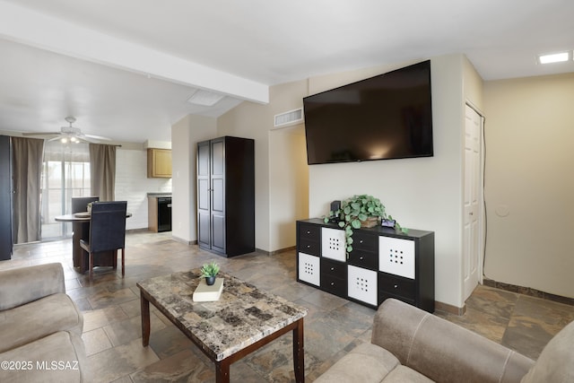 living room featuring ceiling fan and vaulted ceiling with beams