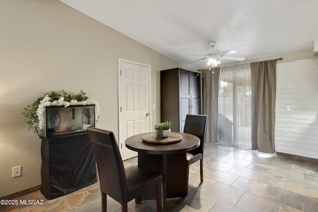 dining space featuring vaulted ceiling and ceiling fan