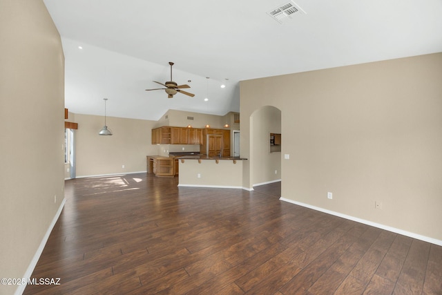 unfurnished living room with ceiling fan, dark hardwood / wood-style flooring, and high vaulted ceiling