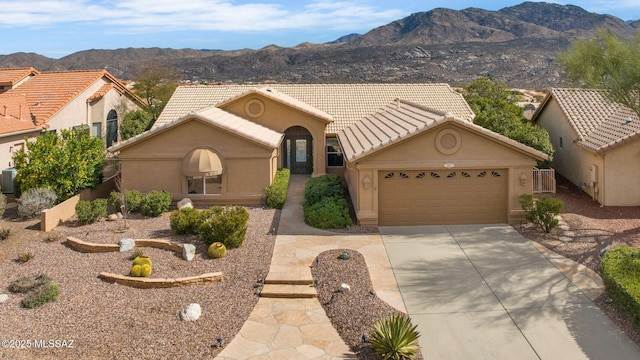 view of front of house with a mountain view and a garage