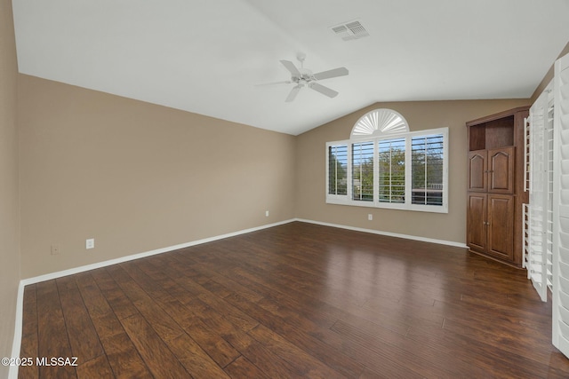 unfurnished bedroom with dark hardwood / wood-style flooring, lofted ceiling, and ceiling fan