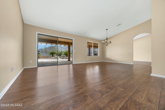 unfurnished room with dark hardwood / wood-style flooring and a chandelier