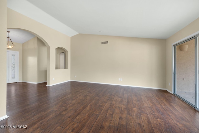 unfurnished room with dark hardwood / wood-style flooring and vaulted ceiling