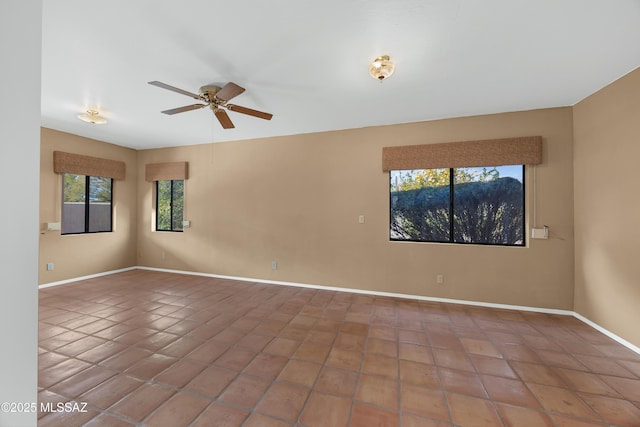 tiled empty room with ceiling fan