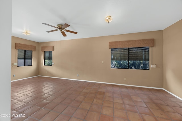 unfurnished room featuring ceiling fan and tile patterned flooring