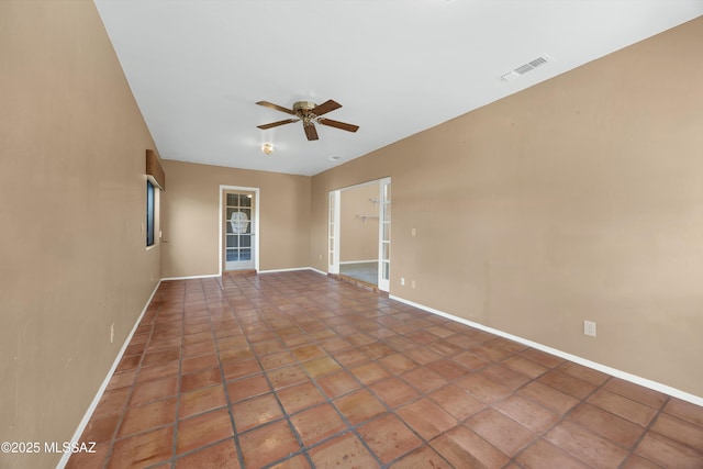 empty room with tile patterned floors and ceiling fan