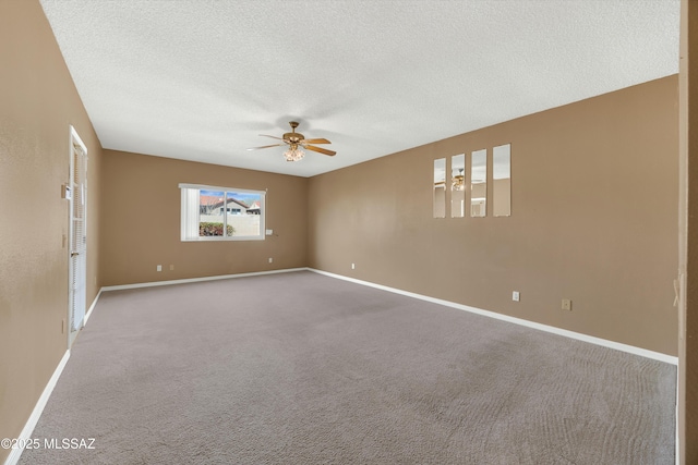 spare room featuring ceiling fan, carpet floors, and a textured ceiling