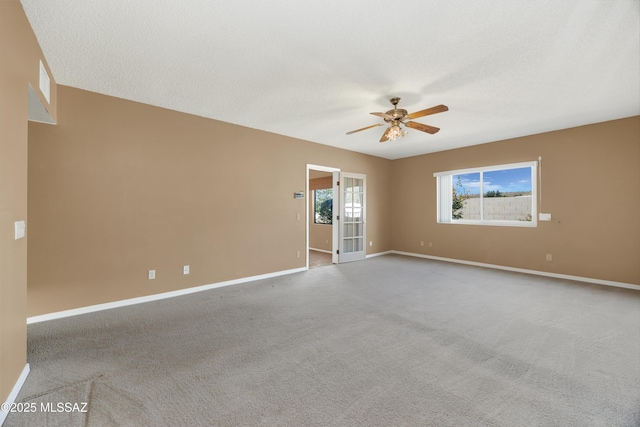 carpeted empty room with a textured ceiling and ceiling fan