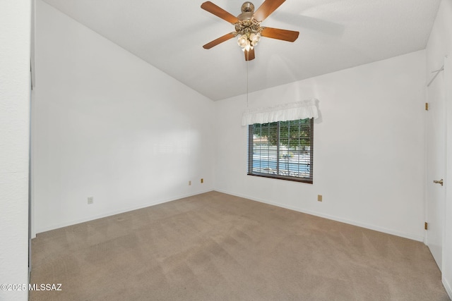 carpeted empty room featuring vaulted ceiling and ceiling fan