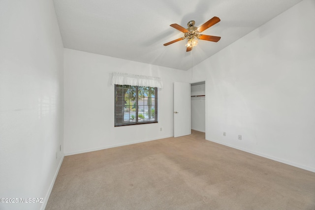 interior space with ceiling fan, light colored carpet, vaulted ceiling, and a closet