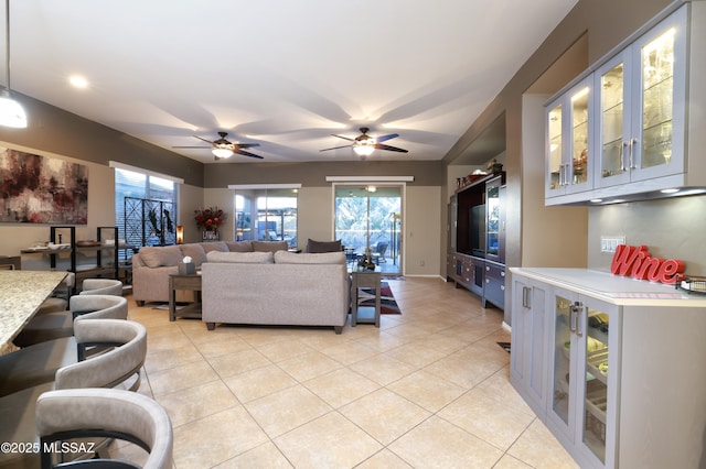 tiled living room with ceiling fan