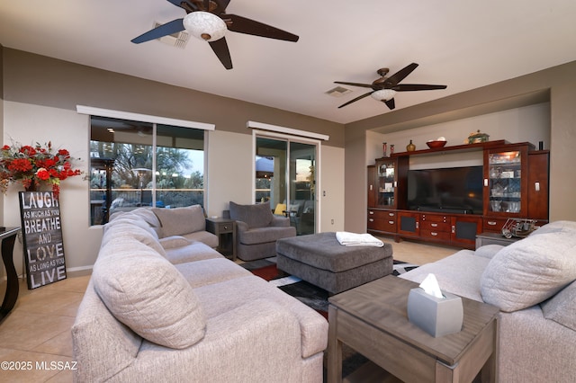 living room with light tile patterned floors and ceiling fan