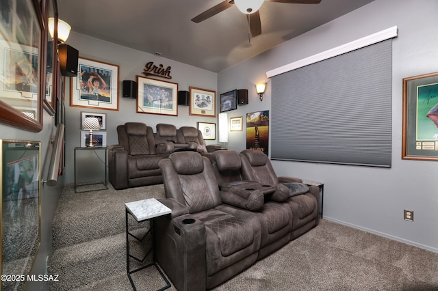 carpeted home theater room with ceiling fan