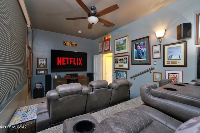 cinema room featuring ceiling fan and carpet