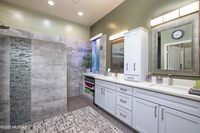 bathroom featuring vanity, tile patterned flooring, and a shower