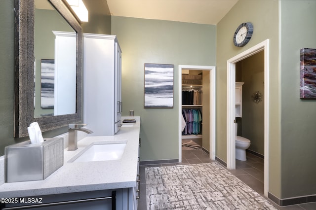 bathroom featuring vanity, toilet, and tile patterned flooring