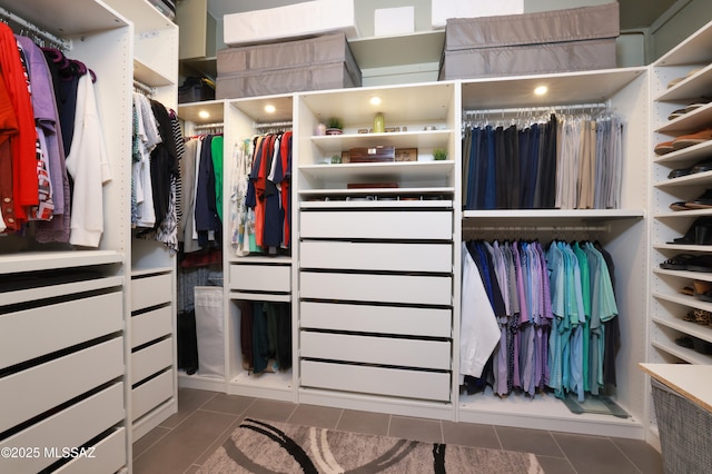 walk in closet with dark tile patterned floors