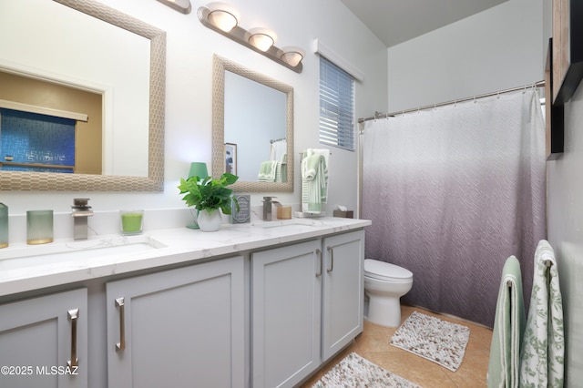 bathroom with vanity, tile patterned floors, and toilet