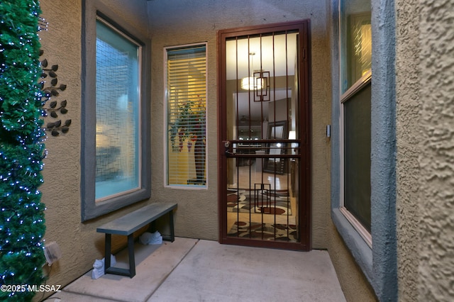 doorway to property with a patio area