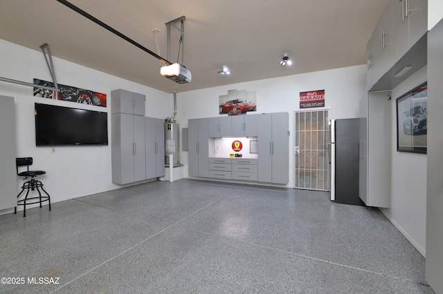 garage featuring water heater and a garage door opener