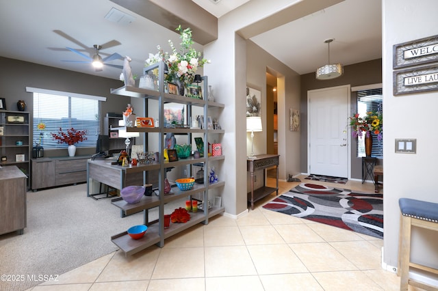 tiled entryway with ceiling fan