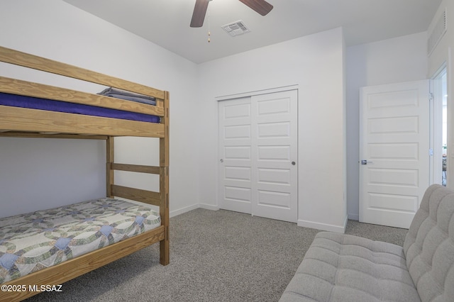 carpeted bedroom with ceiling fan and a closet