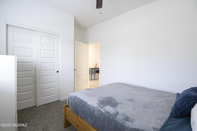 bedroom featuring dark carpet and a closet