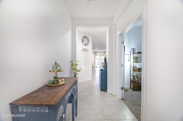 hallway featuring light carpet