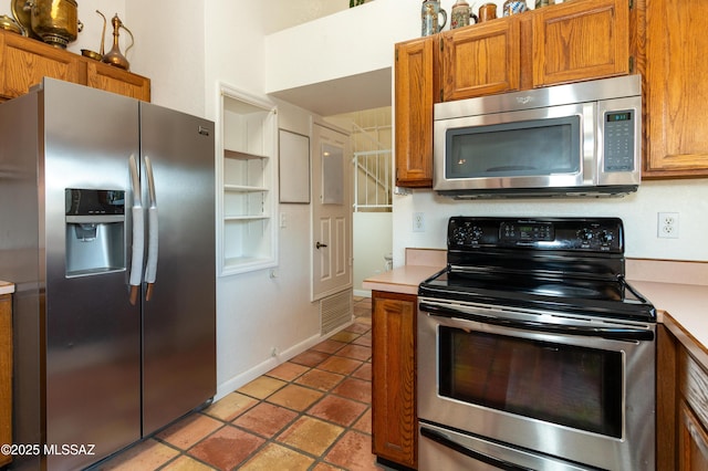 kitchen featuring stainless steel appliances and light tile patterned floors