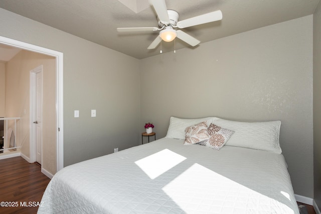 bedroom with ceiling fan and dark hardwood / wood-style flooring