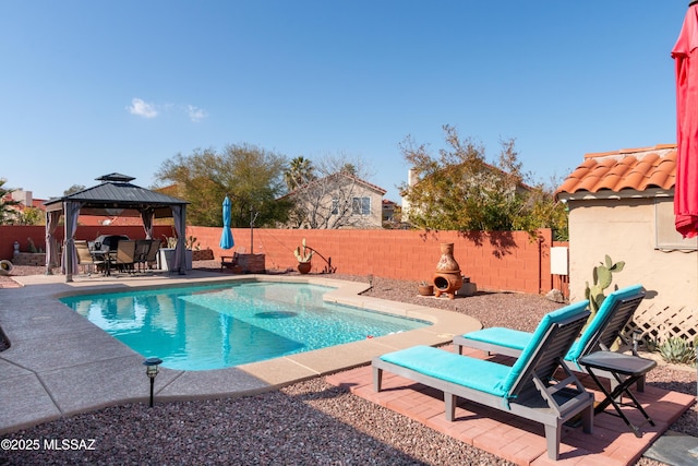 view of swimming pool featuring a gazebo and a patio area