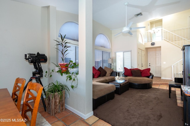 living room with tile patterned flooring, a towering ceiling, and ceiling fan