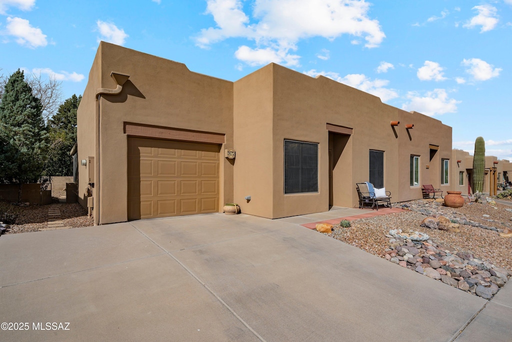 southwest-style home featuring a garage