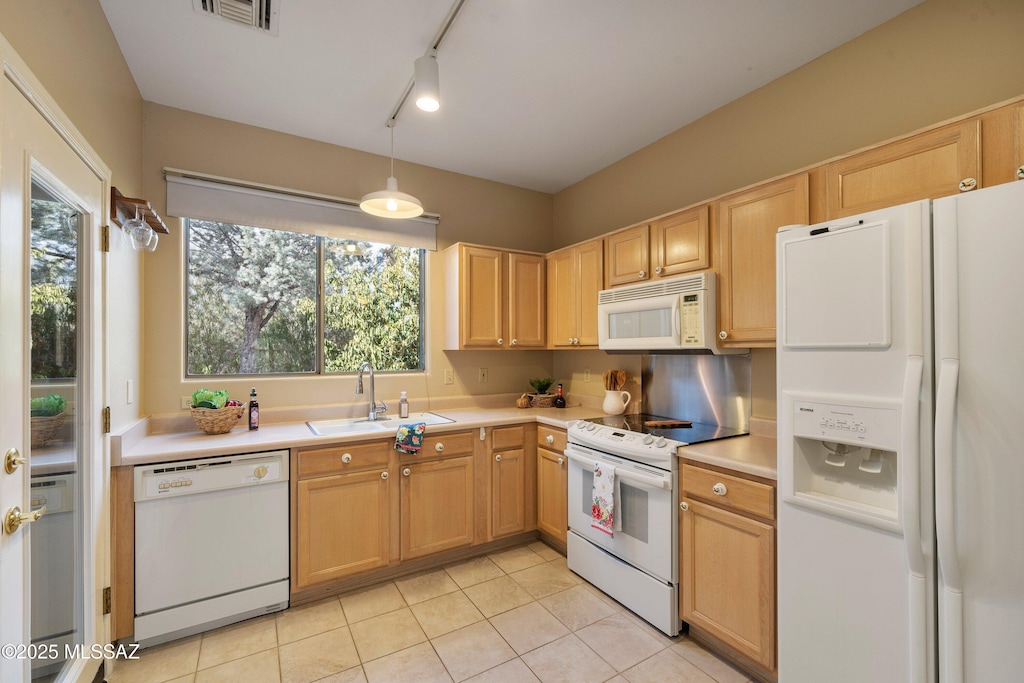 kitchen featuring light countertops, white appliances, a sink, and visible vents