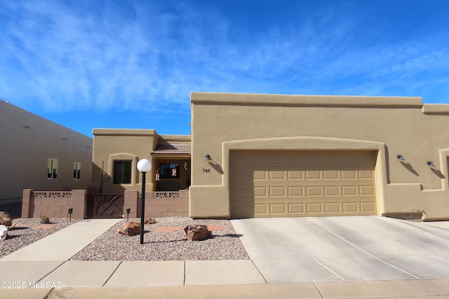 pueblo-style home featuring a garage