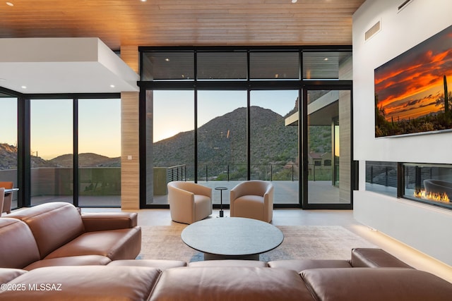 living room featuring a mountain view and wood ceiling