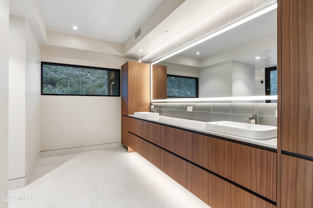 bathroom with vanity and backsplash