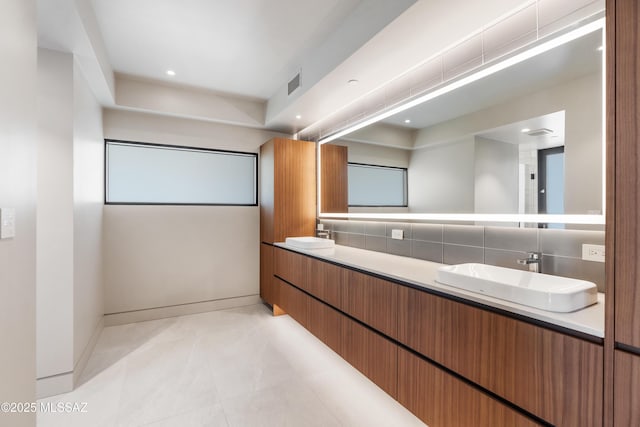 bathroom featuring tasteful backsplash and vanity