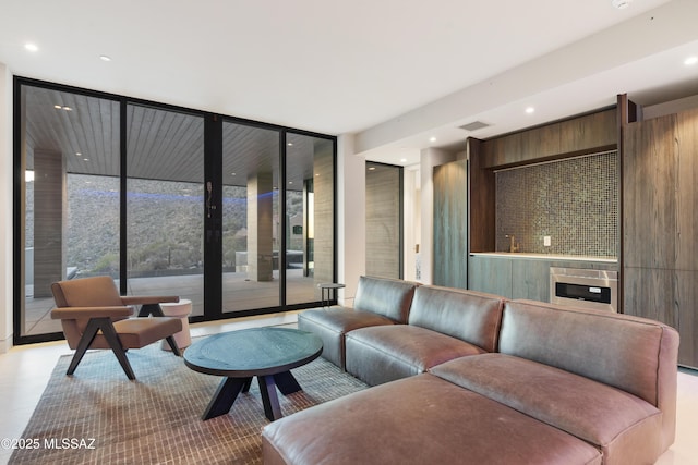 living room with floor to ceiling windows and heating unit